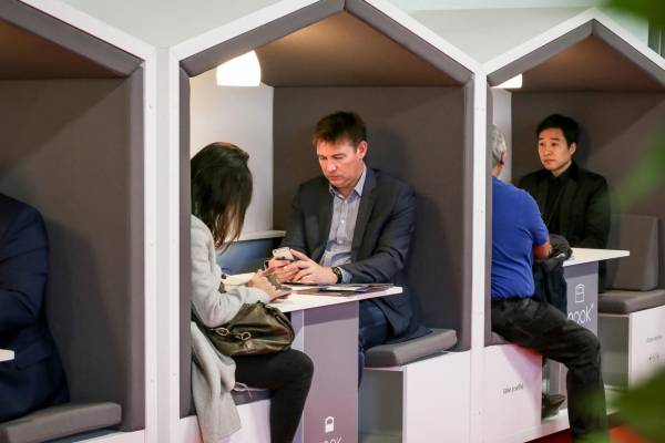 people sitting in booth at trade show